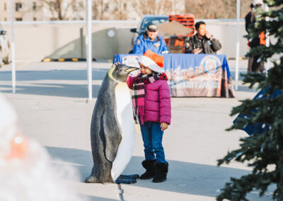 Girl with penguin at Bronx Terminal Market - Winter Wonderland